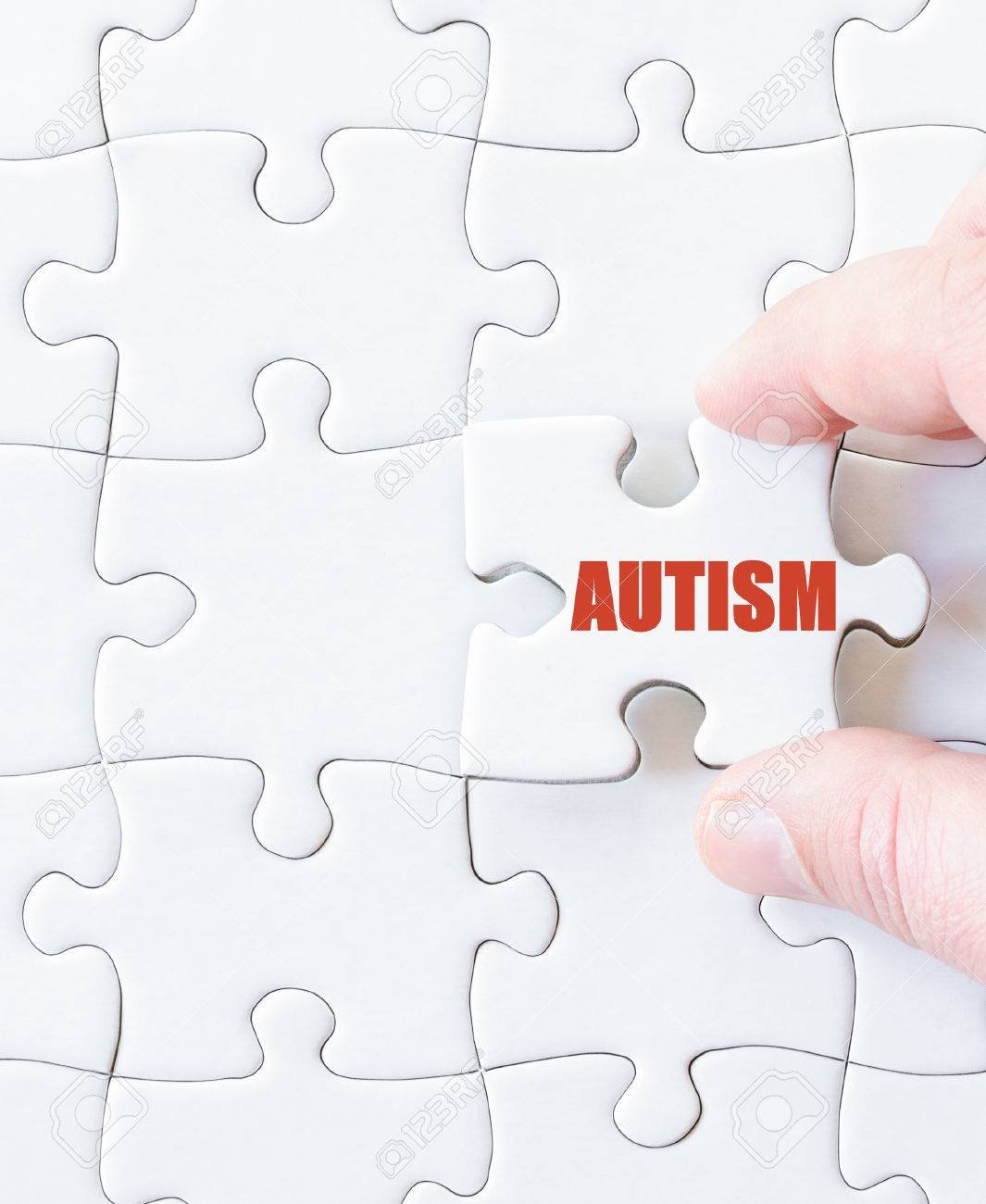 Missing jigsaw puzzle piece with word  AUTISM. Concept image for completing the puzzle.
